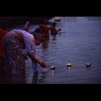 Prayer woman offering floating candels on Ganges, Varanasi