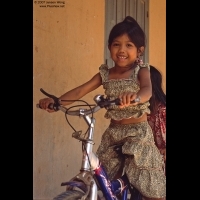 Girl on bike-riding in Wat Dam Nak, Siem Reap