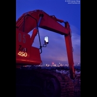 A excavator in Houhai construction site with the Futian skyline in background