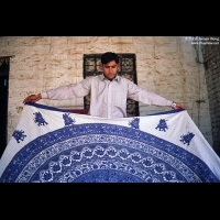 Young craftsman displaying his printing and dyeing cloth