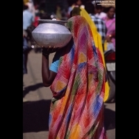 Woman carrying a pot of water