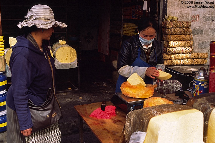 Woman selling Yak Butter, Tromsikhang Market, Lhasa