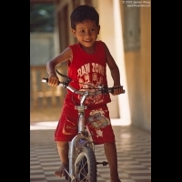 A boy on bike-riding in Wat Dam Nak, Siem Reap