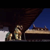 Lion statue under roof eave, Jokhang