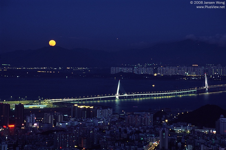 Full moon rising over the Shenzhen Bay