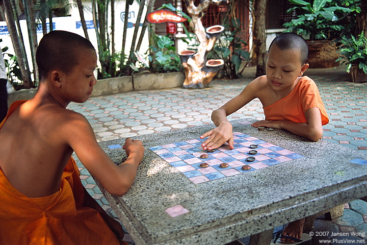 Little monks playing chess