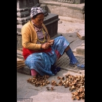 Woman cleaning Yak Butter Lamps, Swayambhunath