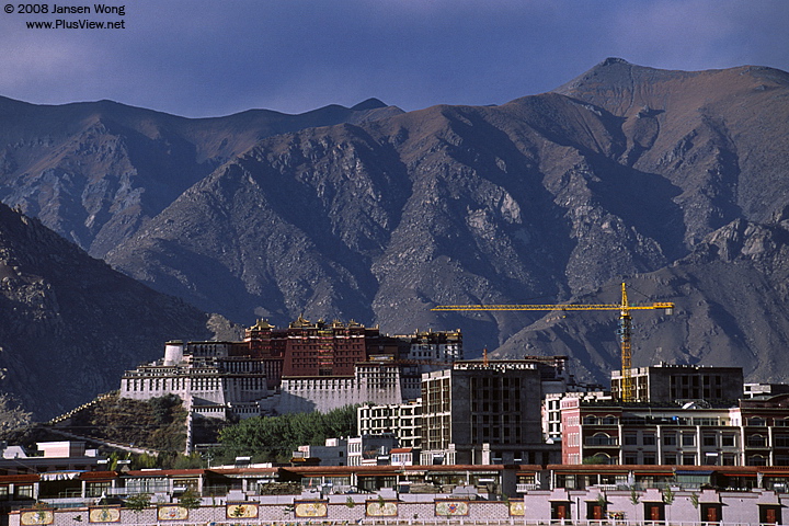 Potala Palace & modern Chinese-style building under construction, Lhasa, Tibet