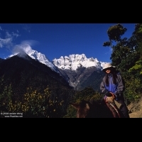 Traveler leaving Yubeng village by riding mule