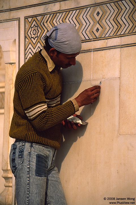 Craftsman maintaining surface of Taj Mahal