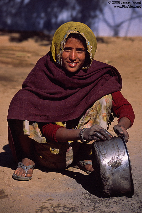 Woman washing saucepot, Akoda Village
