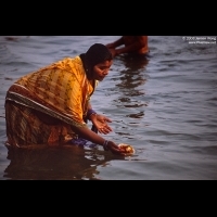 Prayer woman offering floating candel on Ganges, Varanasi